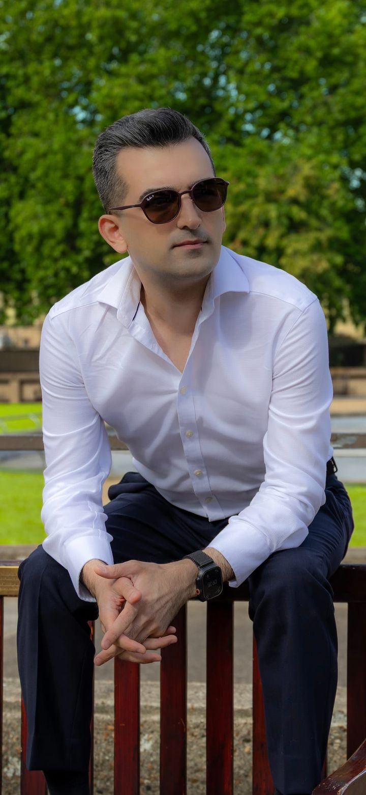 John Adib seated outdoors in London